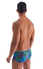 Extreme Low Square Cut Swim Trunks in Tan Through Neon Ferns, Rear View
